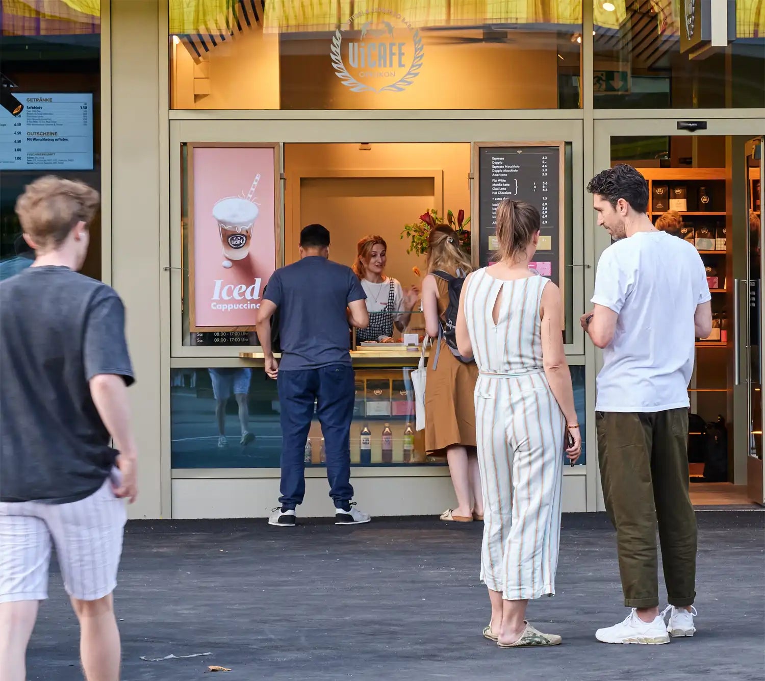 People waiting outside a ViCAFE Espresso Bar in Oerlikon