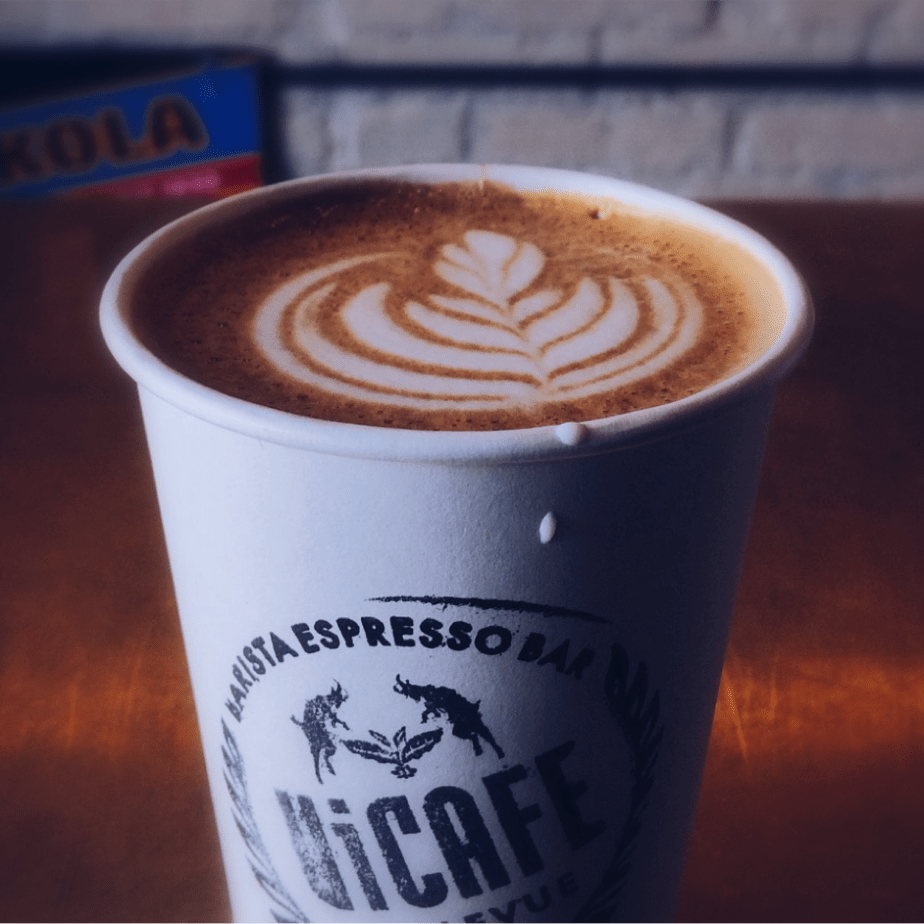 flat white coffee in a cup with vicafe label
