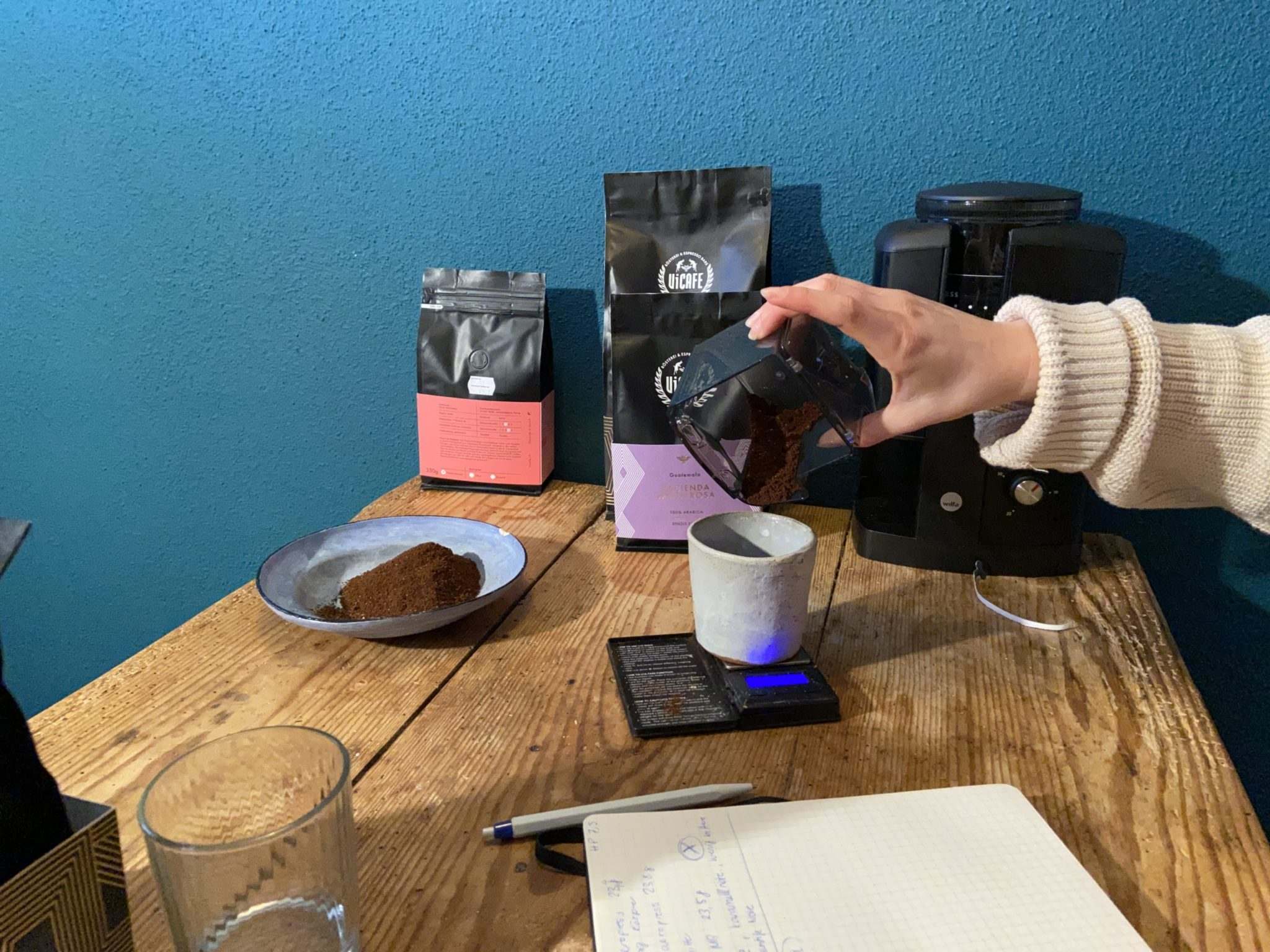 hand measuring coffee on scale